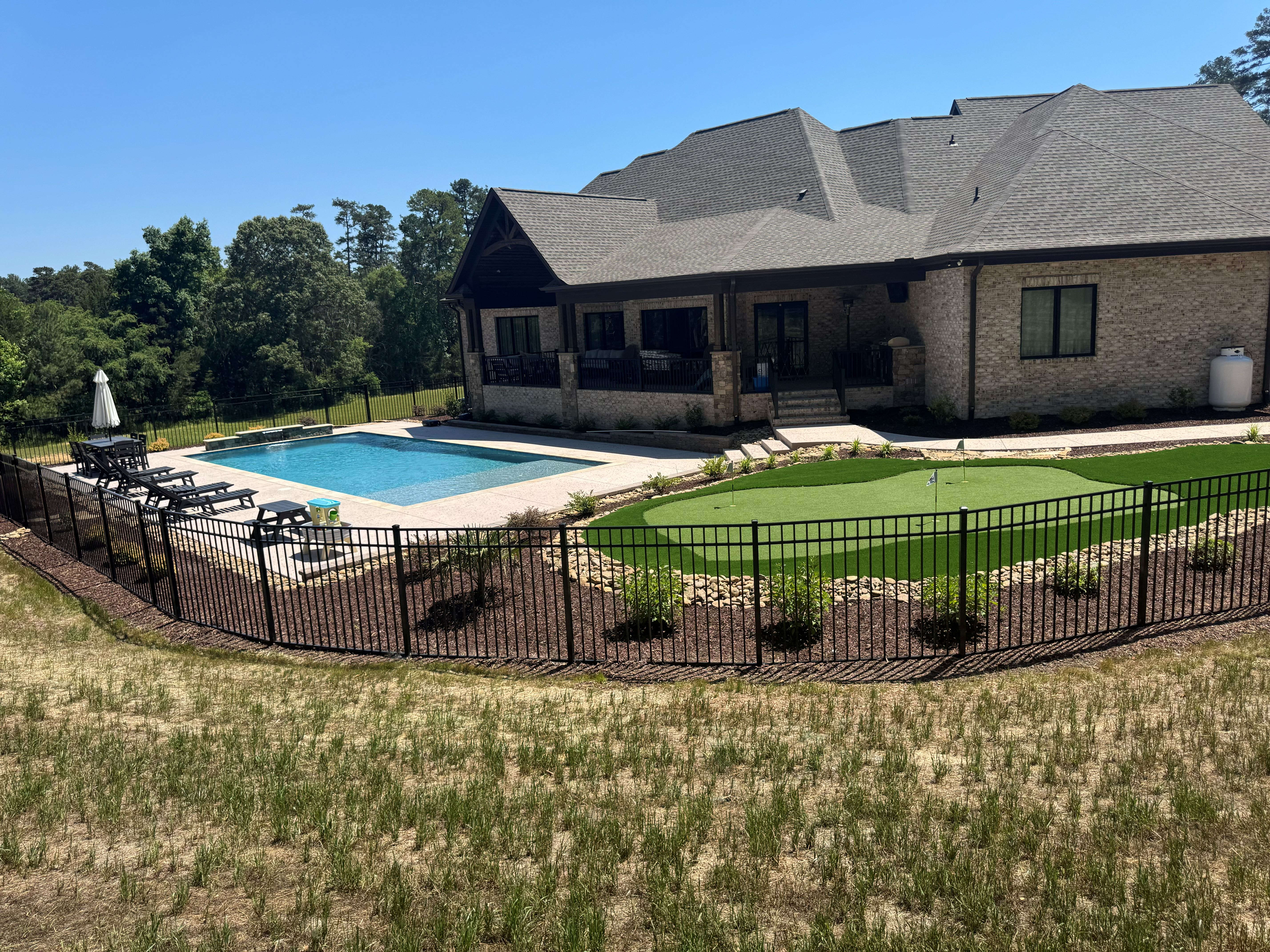 Luxury pool with putting green and outdoor living area