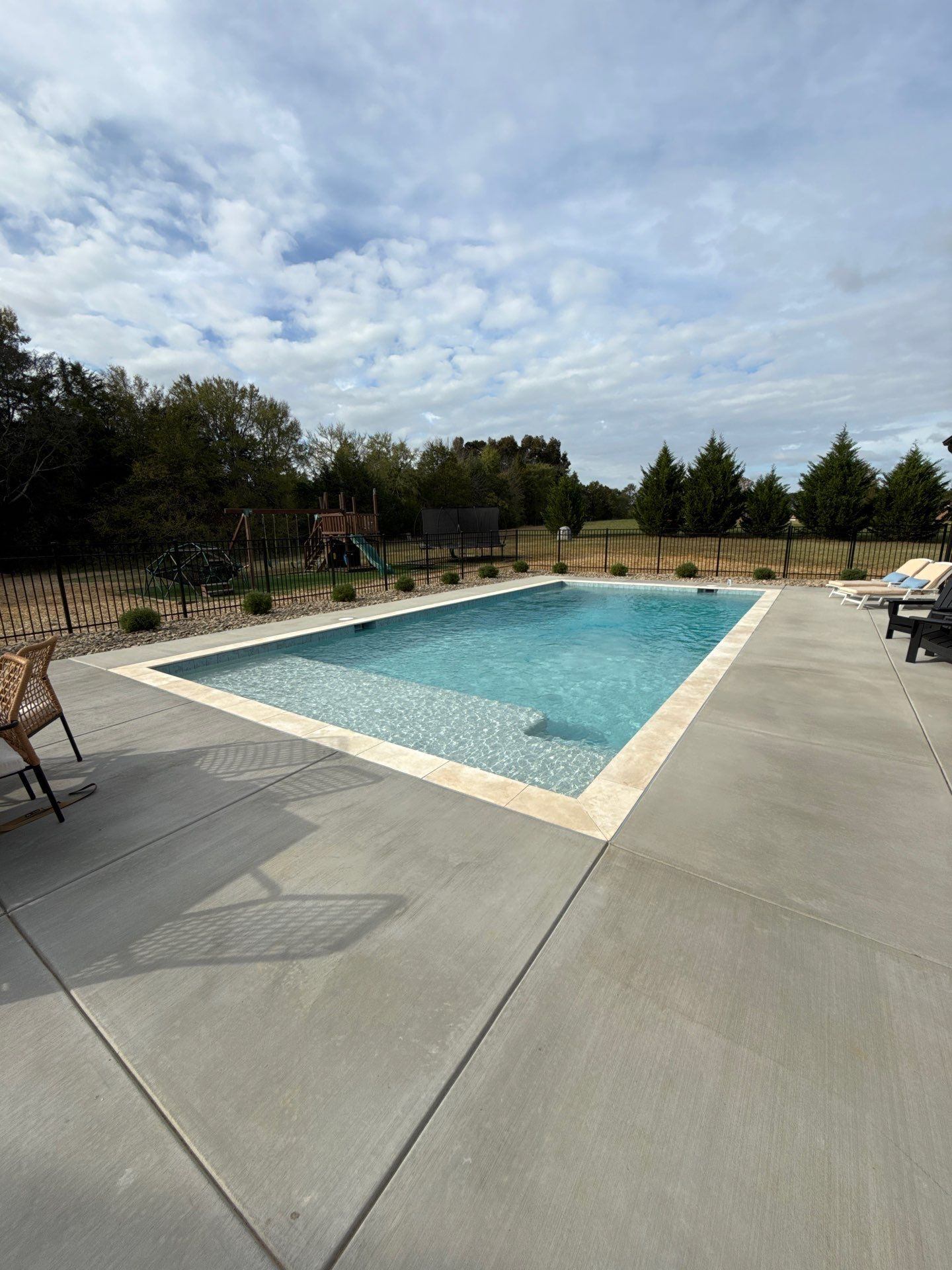 Backyard pool with outdoor kitchen and patio